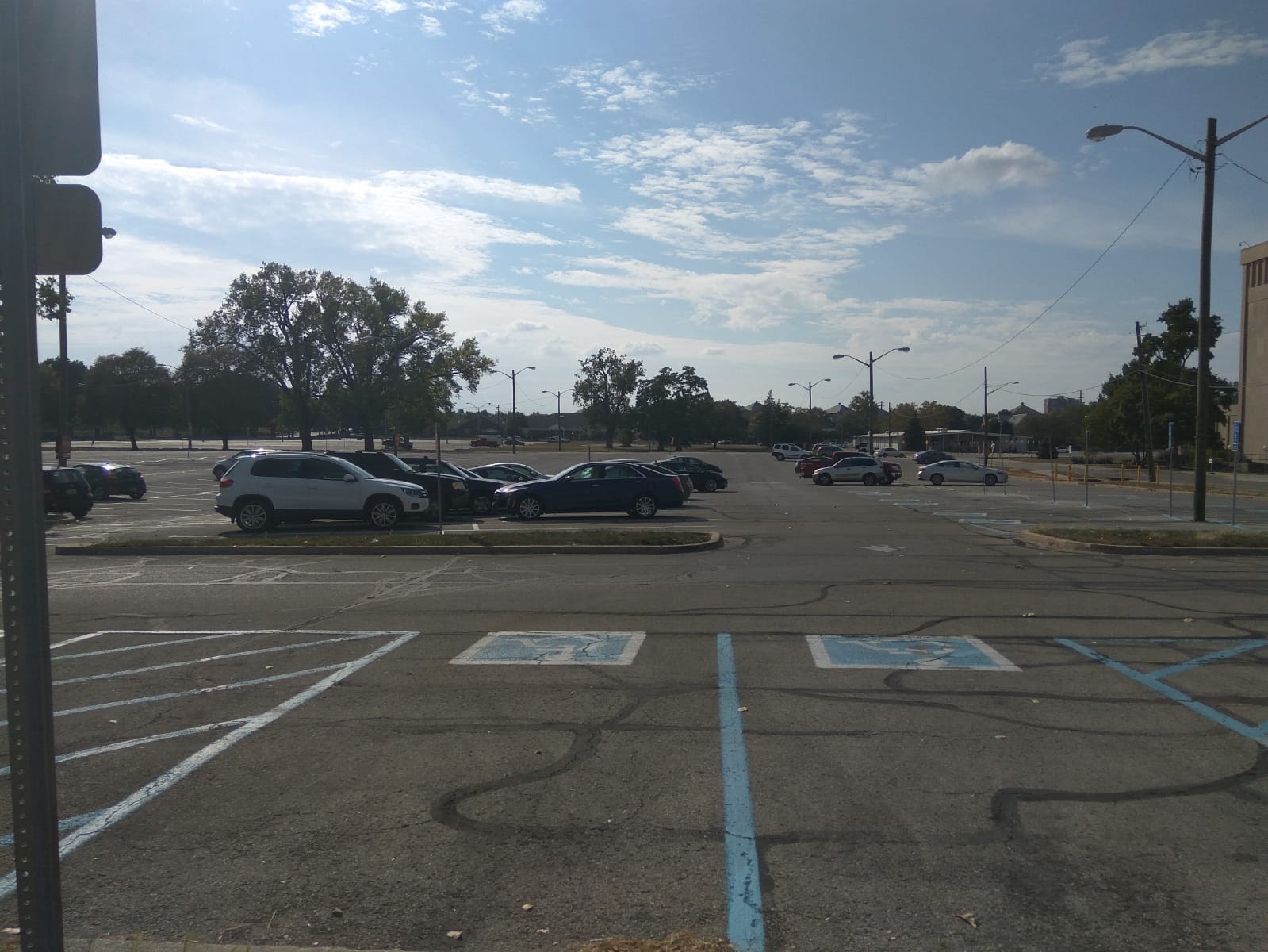 Parking lot with fewer trees, more empty spaces